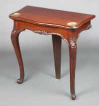 An Edwardian mahogany console table of serpentine outline fitted 2 scallop shaped gilt metal