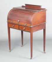 An Edwardian inlaid mahogany cylinder bureau with raised back and well fitted interior above 2