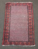 A red and blue ground Afghan rug with central panel and overall geometric design 142cm x 87cm The