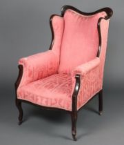 An Edwardian Art Nouveau mahogany show frame chair upholstered in pink material raised on cabriole