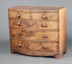 A 19th Century bleached mahogany bow front chest of 2 short and 3 long drawers with turned