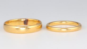 Two 22ct yellow gold wedding bands 7.4 grams, size J 1/2 and Q