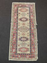 A white, blue and red Caucasian style runner with 5 stylised octagons to the centre 161cm x 66cm