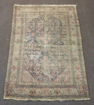 A blue and green ground Persian rug with central floral panel within a multi row border 194cm x