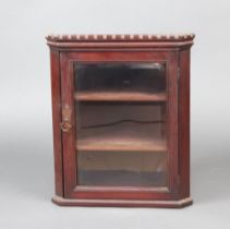A Victorian mahogany hanging corner cabinet with moulded and dentil cornice, fitted a shelf enclosed