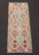 A sand, turquoise and tan ground Chobi Kilim runner with overall geometric designs 160cm x 62cm