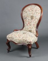 A Victorian mahogany show frame nursing chair, the seat of serpentine outline, upholstered in