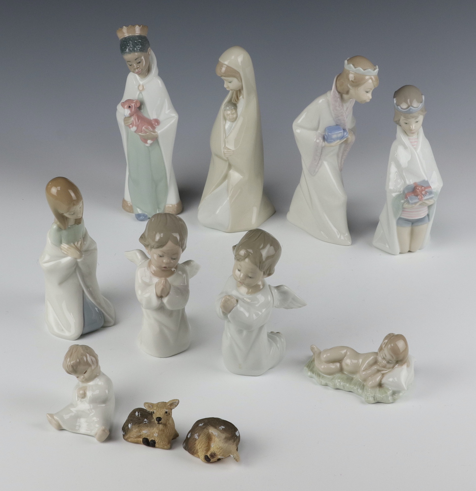 A Lladro Nativity group comprising Mary 19cm, Three Kings 22cm, 2 angels 4538 13cm, a kneeling