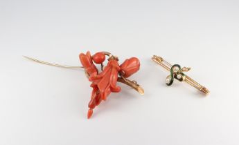 A Victorian yellow metal carved coral floral spray brooch (chipped and missing a droplet) together