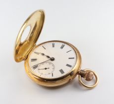 An 18ct yellow gold half hunter mechanical pocket watch with seconds at 6 o'clock contained in a