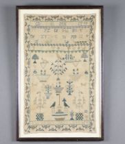 A 19th Century sampler with alphabet, vases of flowers, trees, birds and dogs by Anne Skellorn 1844,