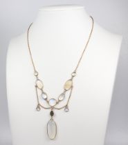 An Edwardian yellow metal moonstone and peridot necklace 7.6 grams, 40cm