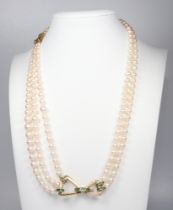 A fine yellow metal diamond and princess cut cultured pearl triple and double strand necklace set
