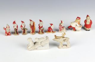 A collection of Victorian bisque Christmas cake decorations comprising 9 figures, a reindeer and 2