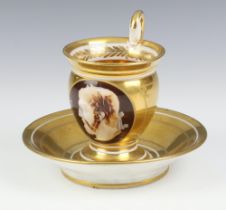 A 19th Century Continental cabinet cup and saucer with mask decoration Gela