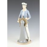 A Lladro figure of a sailor standing at a ships wheel 5206 33cm