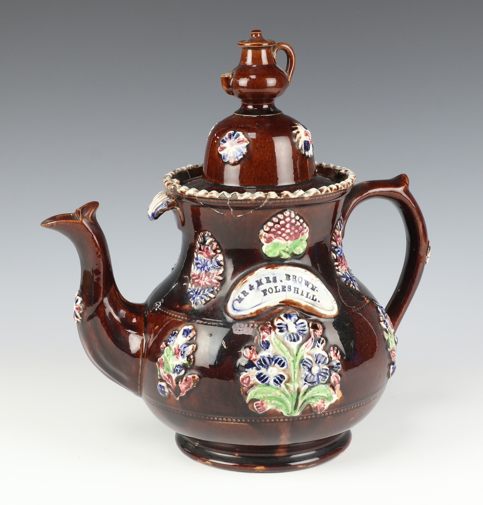 A Victorian Barge Ware teapot, the lid with teapot finial, the body with panels of flowers inscribed