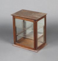 An Edwardian oak table top display cabinet fitted shelves enclosed by a glazed panelled door 49cm