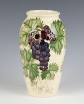 A contemporary Moorcroft Collector's Club vase, the cream ground decorated with grapes 18cm