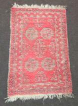 A red and blue ground Afghan rug with 4 octagons to the centre 107cm x 68cm