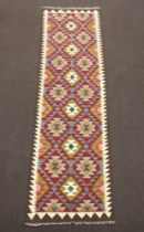A tan, blue and green ground Maimana Kilim runner with all over diamond design 286cm x 79cm