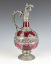 A 19th Century Continental cranberry glass ewer with pewter mounts decorated with figures 33cm