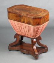 A Victorian octagonal inlaid mahogany work box of waisted form, raised on scroll supports with