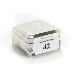 A GEORGE VI SILVER TRINKET BOX of canted corner square design, ribbon tied cartouche to lid,