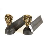 A PAIR OF FRENCH STYLE CAST-IRON ANDIRONS with brass lion mask head fronts. £25-£40.
