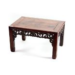 A 19TH CENTURY CHINESE HARDWOOD LOW TABLE with pierced scrolling friezes,