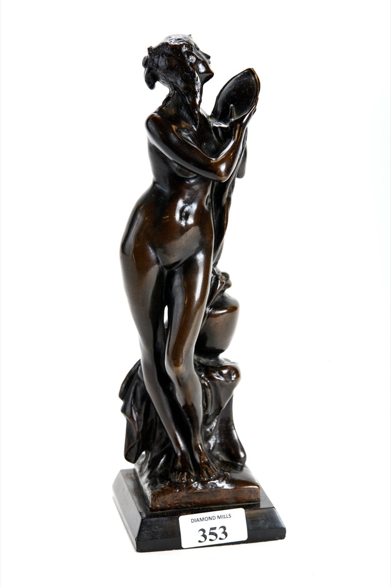 AN ART NOUVEAU PATINATED BRONZE OF VENUS BATHING, unsigned, on a black marble base, 30.5cms high.