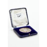 A SOLID SILVER MEDALLION, awarded by the Worshipful Company of Carpenters to WM. G.