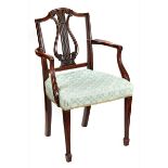 A GEORGE III HEPPLEWHITE PERIOD MAHOGANY ELBOW CHAIR with pierced lyre and plume back,