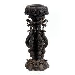 A LATE 19TH CENTURY CARVED BURMESE HARDWOOD JARDINIERE raised on grotesque headed entwined column