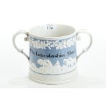 A VERY LARGE 19TH CENTURY POTTERY TWIN HANDLED HUNTING MUG, inscribed "The Leicestershire Hunt",