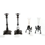 A PAIR OF LATE 19TH CENTURY ZIMMERMAN (HANAU) CAST-IRON CANDLESTICKS raised on circular bases with