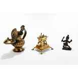 AN ANTIQUE INDIAN HINDU BRASS LAMP decorated with a figure of Ganesha, 14cms,