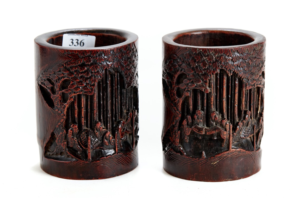 A PAIR OF 19TH CENTURY CHINESE CARVED BAMBOO BRUSH POTS decorated with figures in a landscape,