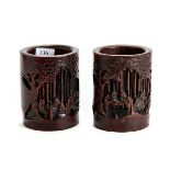 A PAIR OF 19TH CENTURY CHINESE CARVED BAMBOO BRUSH POTS decorated with figures in a landscape,
