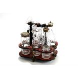 SMALL AND HIPKISS, A 19TH CENTURY SCARLET PAPER-MACHE SIX-BOTTLE CRUET with central ebonized handle,