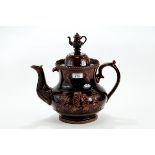 A LARGE 19TH CENTURY TREACLE GLAZE MEASHAM POTTERY BARGE TEAPOT with raised leaf & scroll