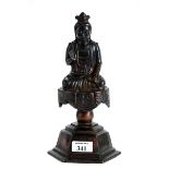 A CHINESE BRONZE FIGURE OF A SEATED BUDDHA raised on a stepped hexagonal base, traces of gilding,
