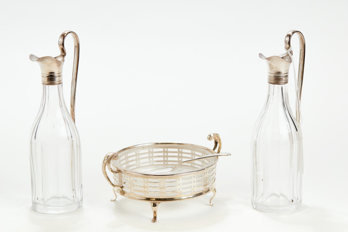 A PAIR OF LATE VICTORIAN DECAGONAL CLEAR GLASS OIL/VINEGAR BOTTLES with silver necks & handles,