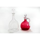 A VICTORIAN CRANBERRY GLASS DECANTER with twisted clear glass side handle and facetted stopper,