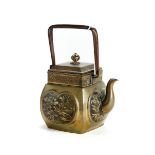 A LATE 19TH CENTURY ORIENTAL BRONZE/BRASS TEAPOT of swollen square form with panels of flowers and