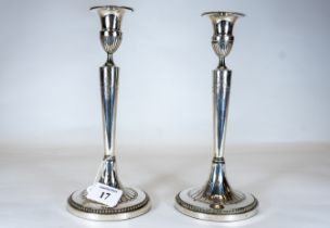 A pair of 18th/19th century European white metal candlesticks, the plain stems with engraved drapery