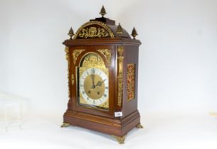 A late 19th century ornate mounted mahogany bracket clock, break arch dial with silvered chapter