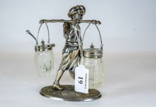A novelty plated three-piece cruet set in the form of an Indian wearing a turban carrying a salt