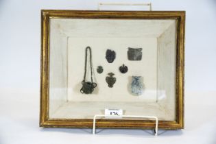 A small collection of antiquities, seven items in a glazed box frame, 26.5 x 32cms, £60 - £80