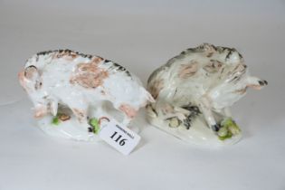 A pair of early 19th Century porcelain Florentine Boars raised on naturalistic flower & acorn strewn